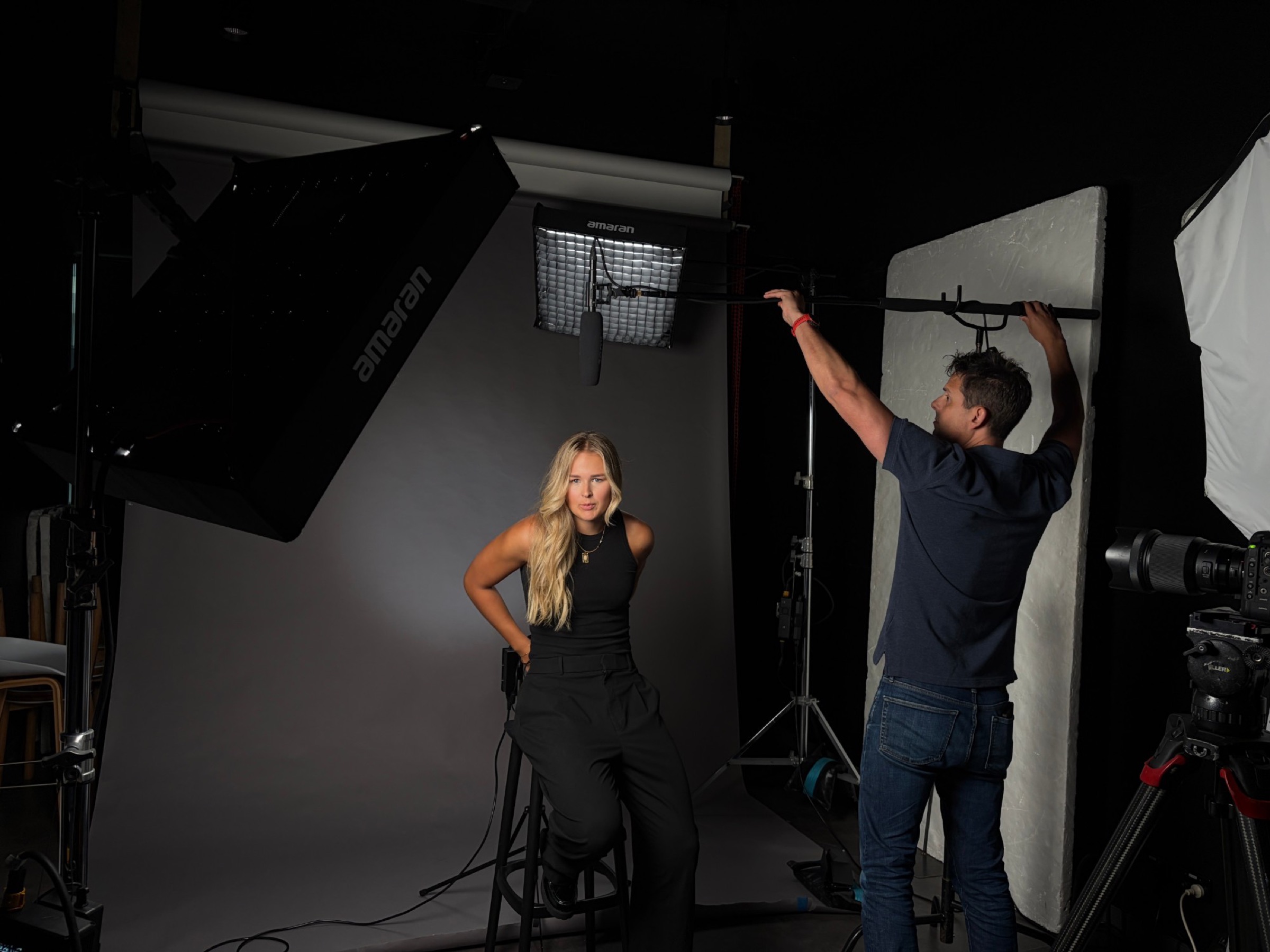 Miff Rennie on set during a studio shoot, lighting being set around her